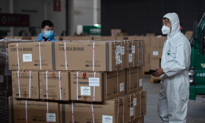 Staff members and volunteers transfer medical supplies at a warehouse of an exhibition center which has been converted into a makeshift hospital in Wuhan, China, on Feb. 4, 2020. (STR/AFP via Getty Images)