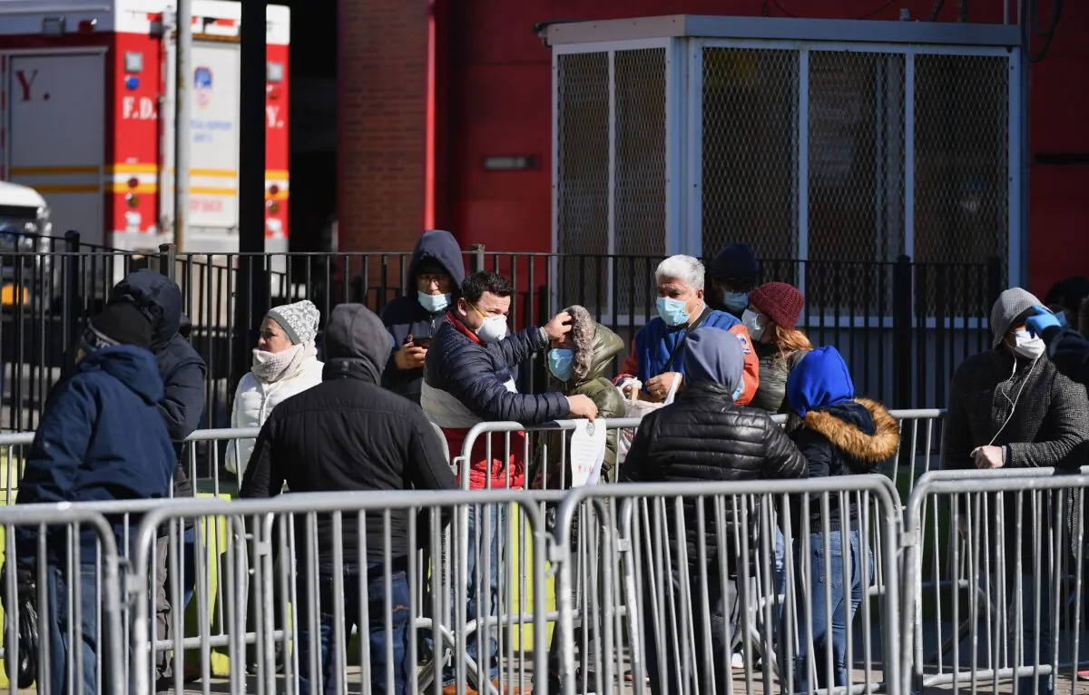 People stand in line to get tested for the CCP virus (COVID-19) at Elmhurst Hospital Center in the Queens borough of New York City on March 26, 2020. (ANGELA WEISS/AFP via Getty Images)