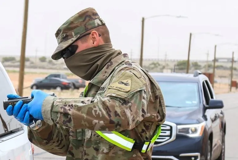 A soldier wears a makeshift face covering at a checkpoint in this handout image from April 6, 2020. (Department of Defense)