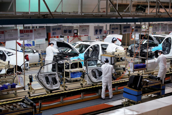 Employees work on a production line inside a Dongfeng Honda factory