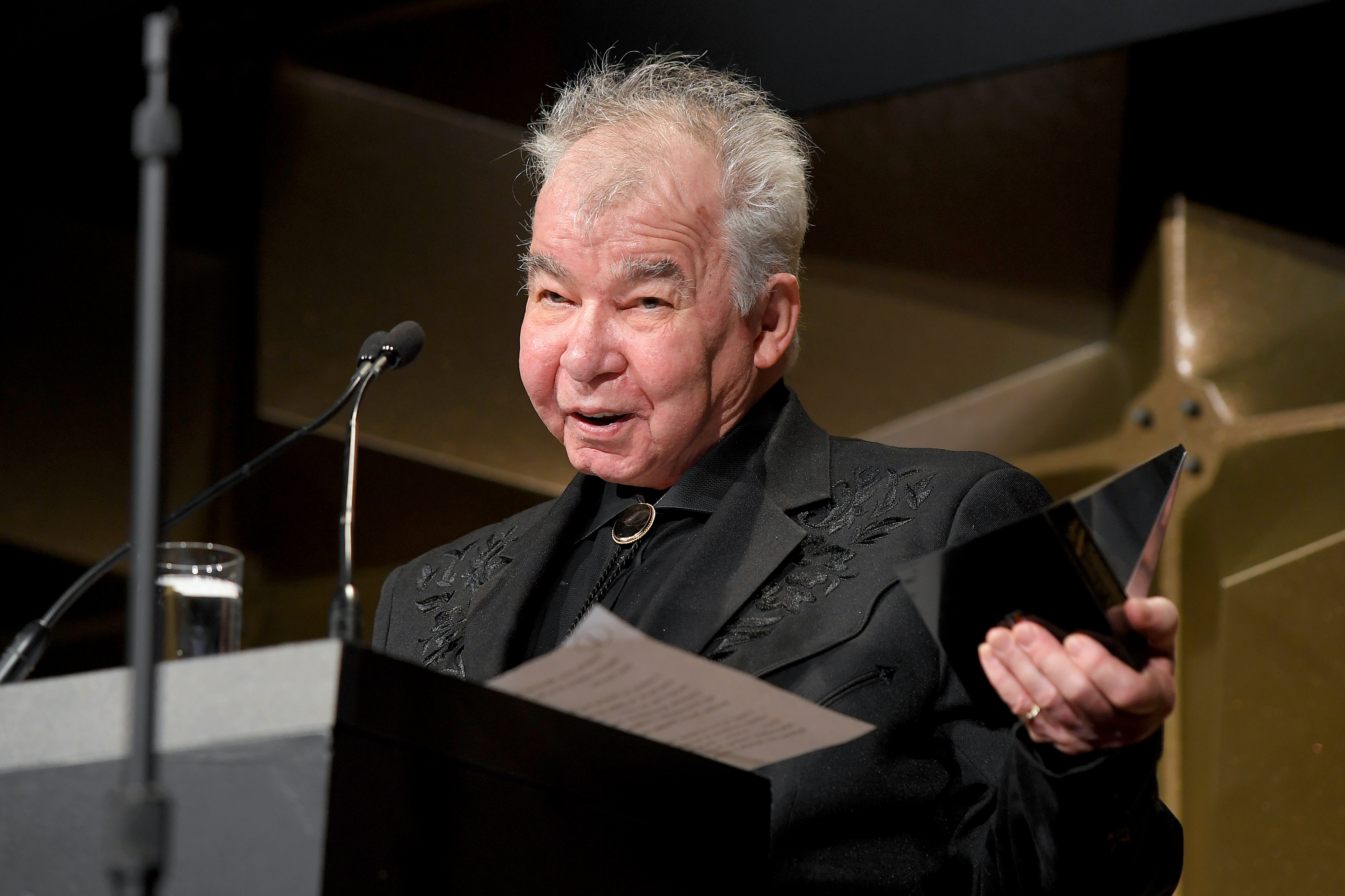 John Prine speaks onstage