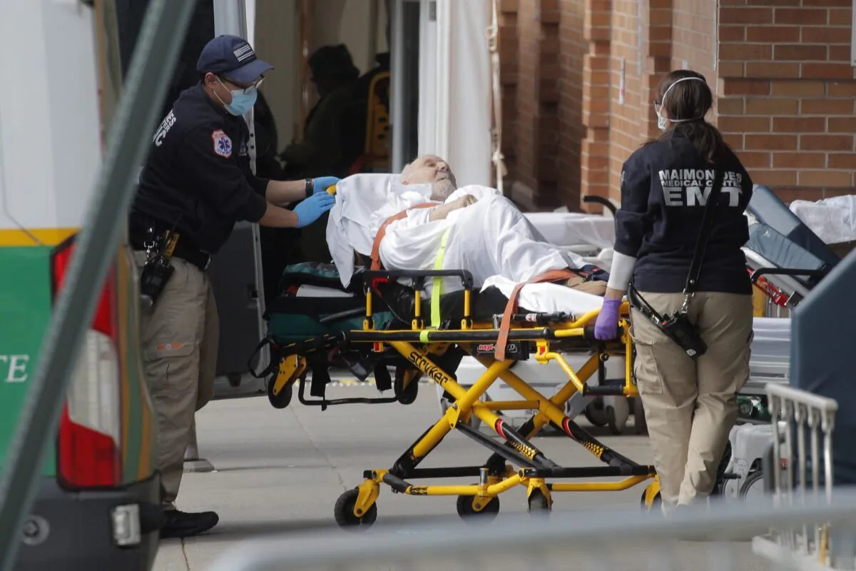 Paramedics take a patient into a hospital during the outbreak of the CCP virus in the Brooklyn borough of New York City, New York on April 7, 2020. (Brendan Mcdermid/Reuters)