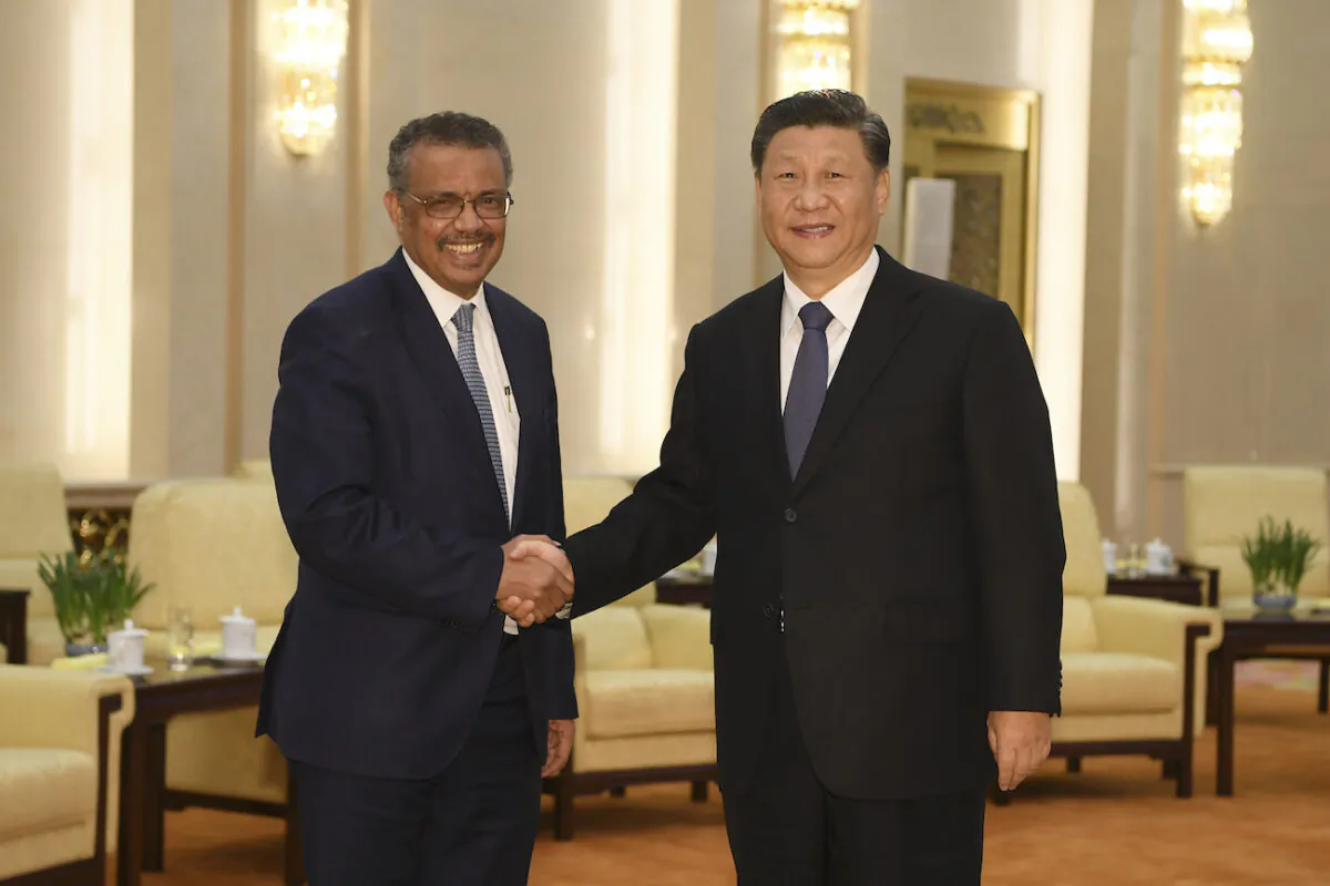 World Health Organization director general Tedros Adhanom (L) shakes hands with Chinese regime leader Xi jinping before a meeting at the Great Hall of the People in Beijing on Jan. 28, 2020. (Naohiko Hatta/AFP via Getty Images)