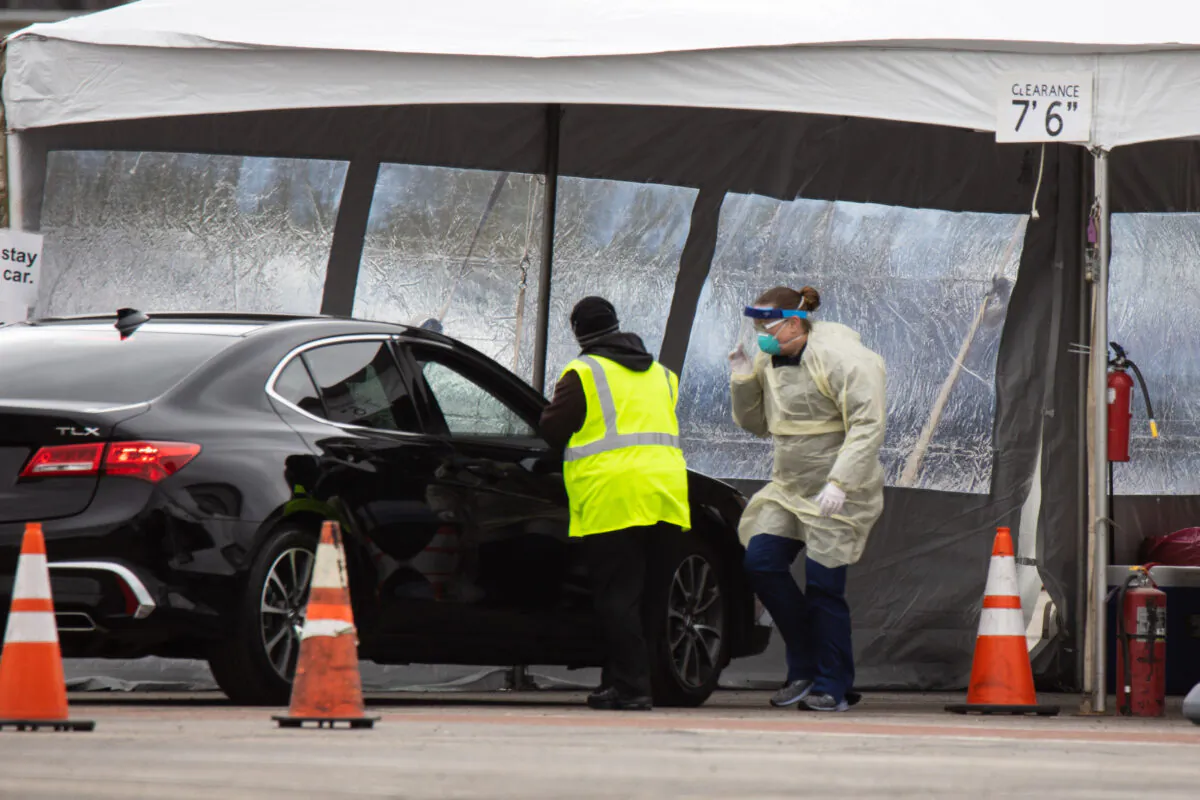 Health professionals conduct CCP virus tests at a drive through testing site at the University of Dayton in Dayton, Ohio, on March 17, 2020. (Megan Jelinger/AFP via Getty Images)
