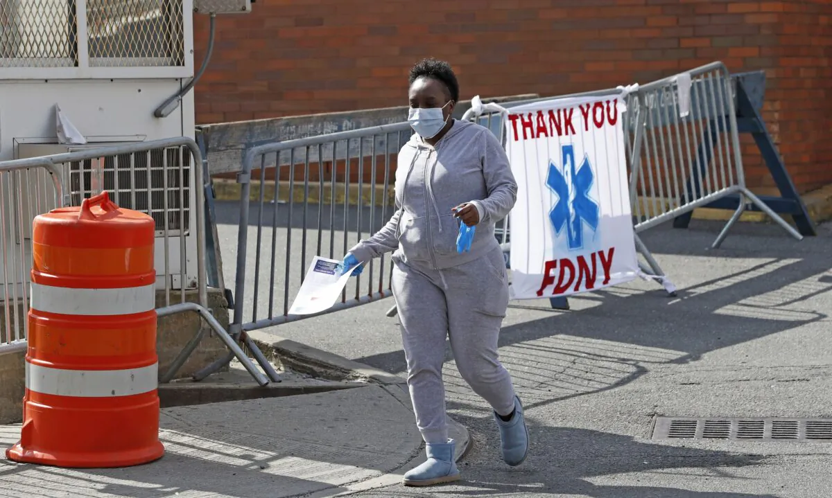A woman leaves Elmhurst Hospital Center after being tested for the CCP virus during the current viral pandemic in the Queens borough of New York on April 7, 2020. (Kathy Willens/AP Photo)