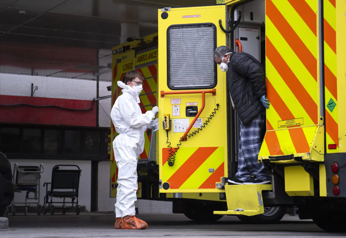 A man with an unknown condition is helped from an ambulance at the St Thomas' Hospital in London on March 30, 2020. (Justin Setterfield/Getty Images)