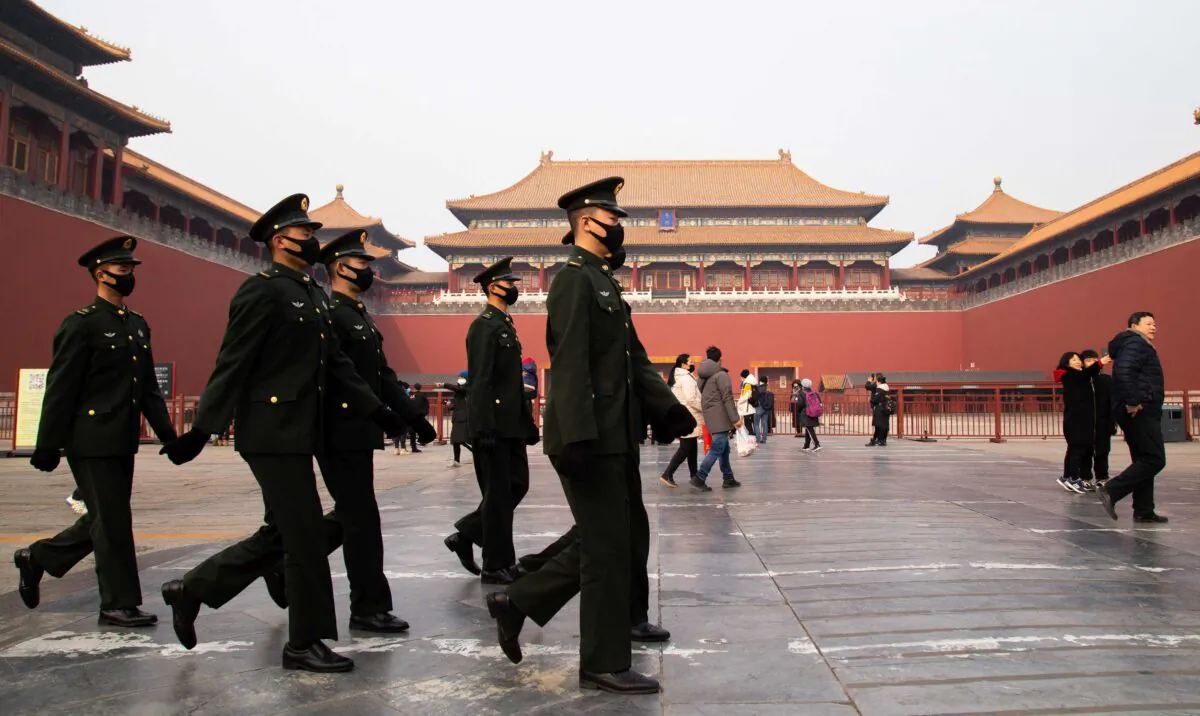 Chinese police officers walk in front of the gated entrance of The Palace Museum in Beijing, China, on Jan. 26, 2020. (Betsy Joles/Getty Images)