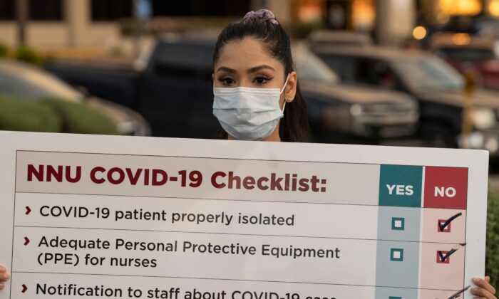 A nurse holds a sign during a demonstration in El Paso, Texas, on April 1, 2020. Gov. Abbott banned most abortions out of concern that all medical resources be used to fight COVID-19. (Paul Ratje/AFP via Getty Images)
