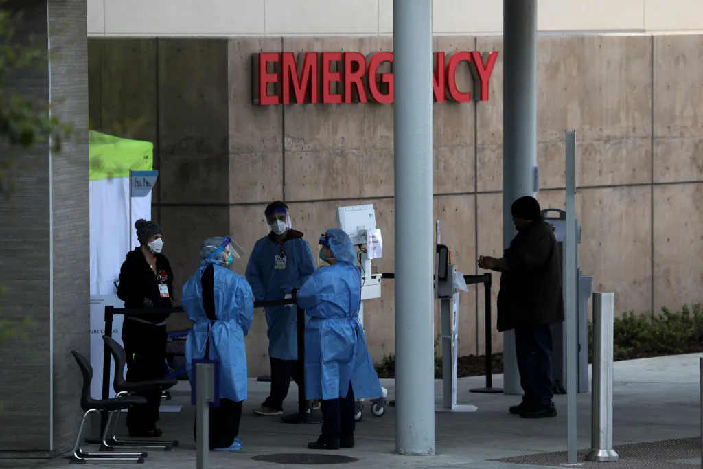 Health care professionals screen people entering the emergency room at Highland Hospital in Oakland, Calif., on March 26, 2020. (Justin Sullivan/Getty Images)