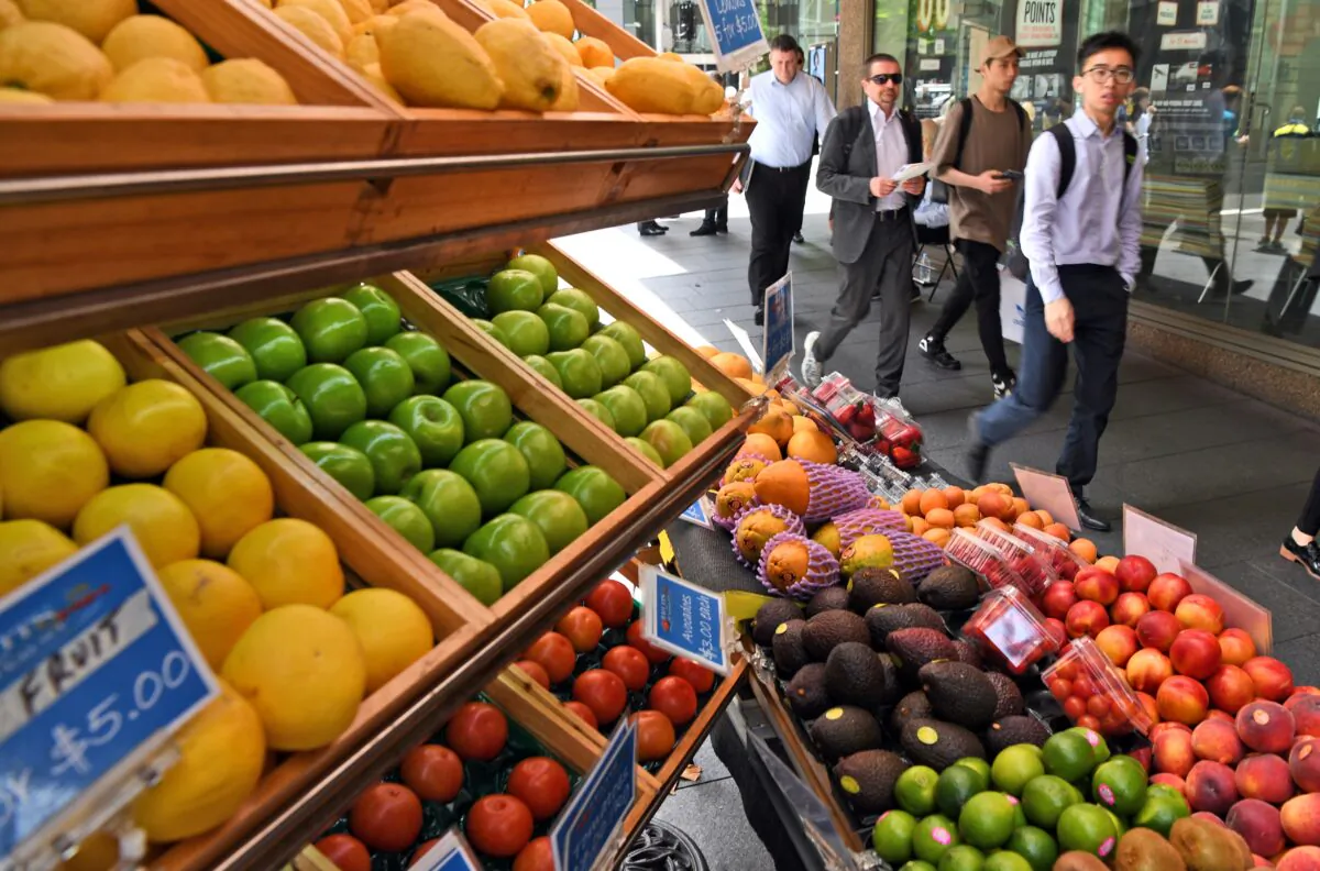 People walk past a fruit stall in Sydney's central business district on November 29, 2016.       
(WILLIAM WEST/AFP via Getty Images)