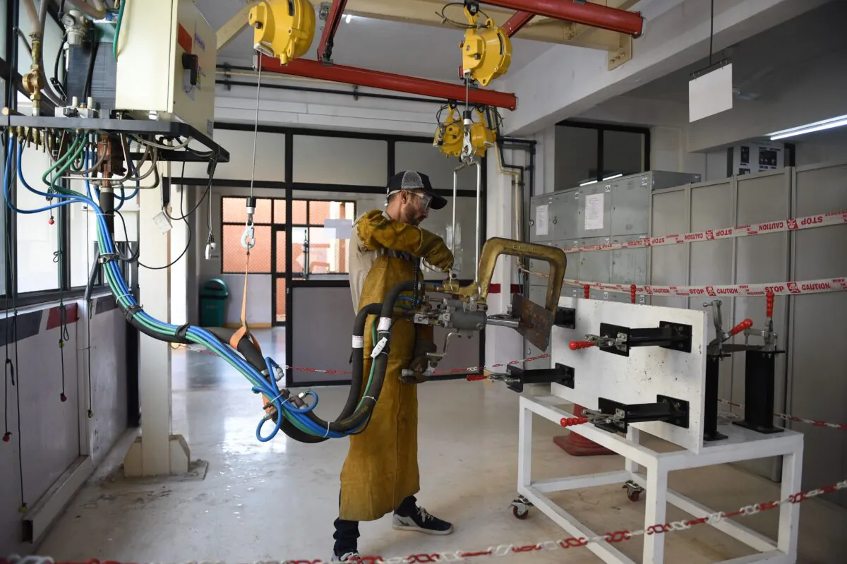A student works on a portable spot welding machine at the Japan-India Institute for Manufacturing (JIM) at Ganpat University in Kherva, India, on Nov. 26, 2018. (Sam Panthaky/AFP/Getty Images)