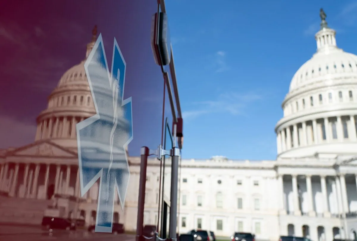 The U.S. Capitol is reflected in a standby ambulance in Washington, on March 27, 2020. (Alex Edelman/AFP via Getty Images)