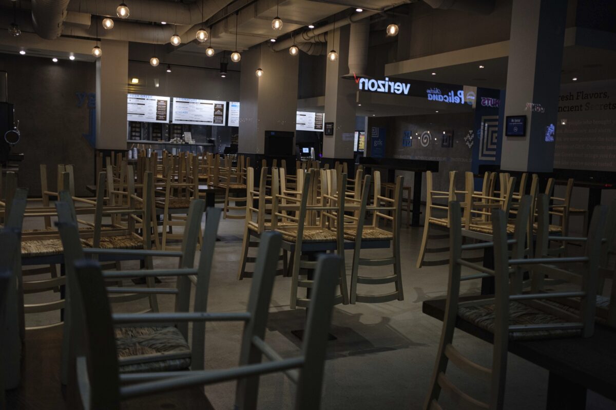 Chairs hang stacked on empty tables at a closed restaurant in New York City on March 16, 2020. (Yuki Iwamura/AP Photo)