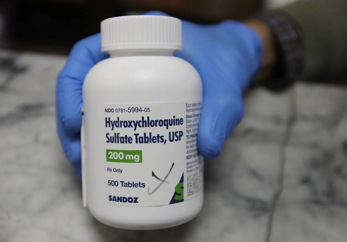 A pharmacist shows a bottle of the drug hydroxychloroquine in Oakland, California, on April 6, 2020. (Ben Margot/AP Photo)