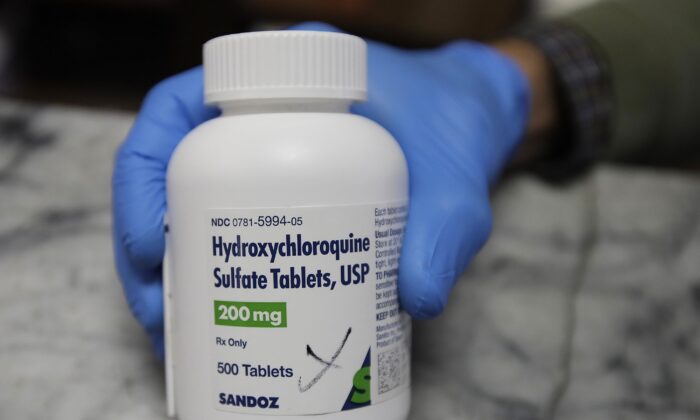 A pharmacist shows a bottle of the drug hydroxychloroquine in Oakland, Calif., on April 6, 2020. (Ben Margot/AP Photo)