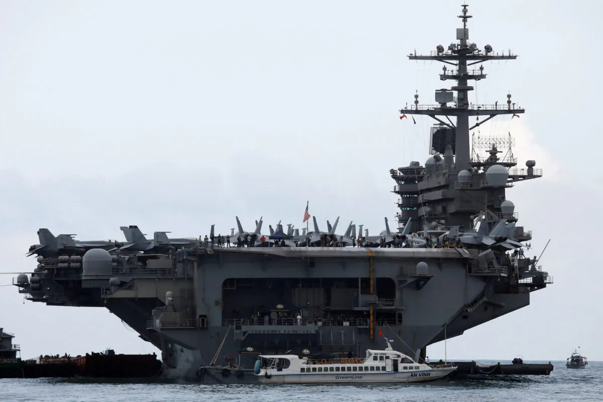 The aircraft carrier Theodore Roosevelt (CVN-71) is seen while entering into the port in Da Nang, Vietnam, on March 5, 2020. (Kham/Reuters)