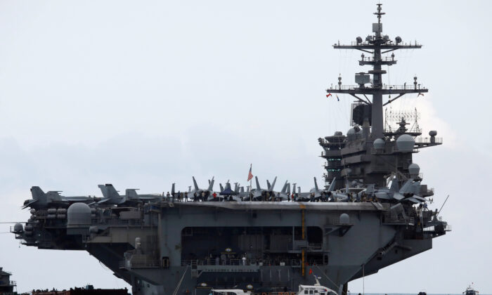 The aircraft carrier Theodore Roosevelt (CVN-71) is seen while entering into the port in Da Nang, Vietnam, on March 5, 2020. (Kham/Reuters)