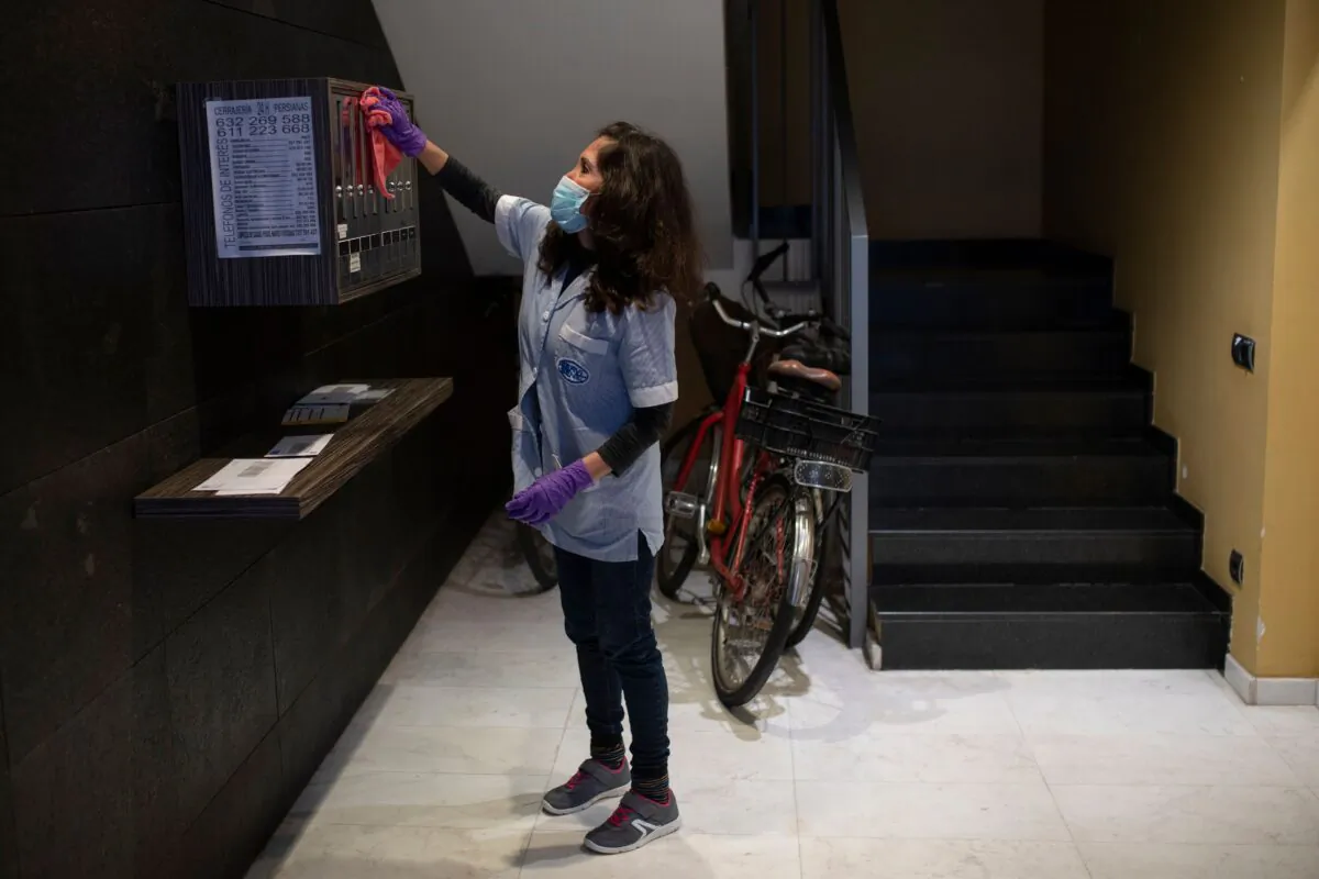 Cecilia Alvarez Velasco, 47, from Ecuador, works cleaning a condominium residence in Barcelona, Spain, on April 9, 2020. (Josep Lago/AFP via Getty Images)