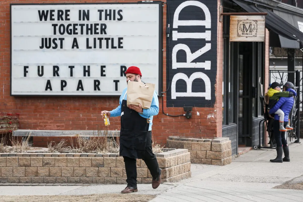 A sign outside a Calgary grocery store amid the COVID-19 pandemic, April 9, 2020. (The Canadian Press/Jeff McIntosh)