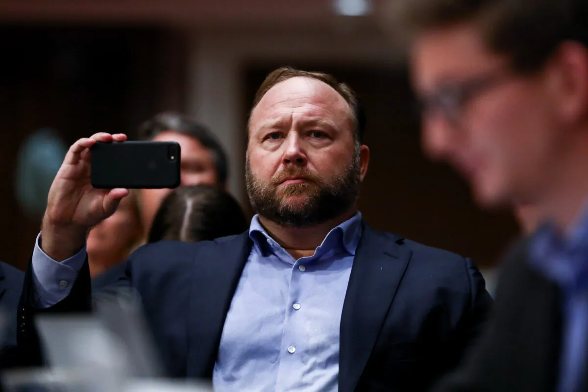 InfoWars founder Alex Jones takes photos at a hearing to examine foreign influence operations' use of social media platforms before the Intelligence Committee at the Capitol in Washington on Sept. 5, 2018. (Samira Bouaou/The Epoch Times)