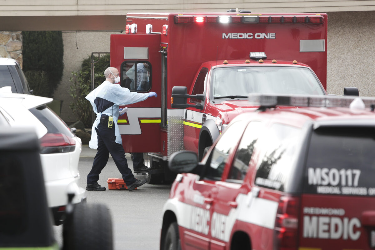 Ambulance staff prepare to transport a patient