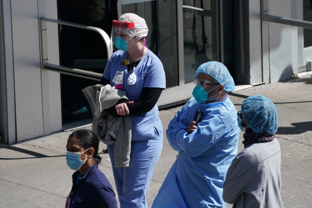 Members of the medical staff listen as Montefiore Medical Center nurses call for N95 masks and other critical PPE to handle the coronavirus (COVID-19) pandemic in New York on April 1, 2020. (Bryan Smith/AFP via Getty Images)