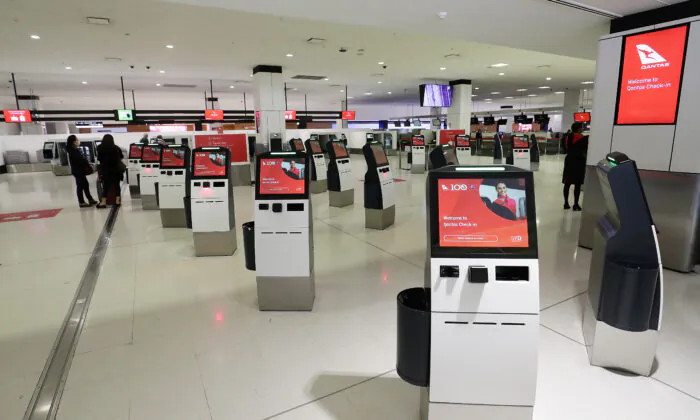 The Qantas check in area is seen empty at Sydney International Airport on March 19, 2020 in Sydney, Australia. Qantas has announced it will ground its entire international fleet, including overseas Jetstar . ( Mark Metcalfe/Getty Images)