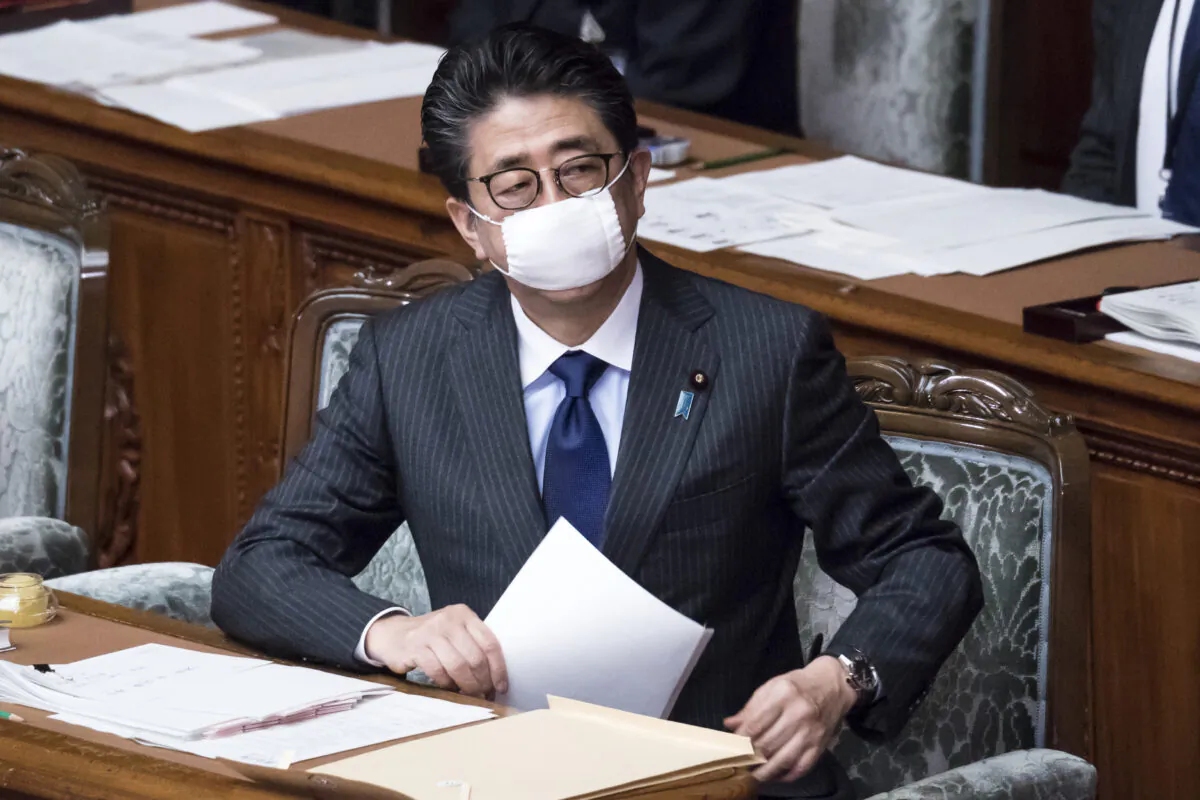 Japan's Prime Minister Shinzo Abe wearing a mask attends an ordinary session at the upper house of parliament in Tokyo on April 2, 2020. (Tomohiro Ohsumi/Getty Images)