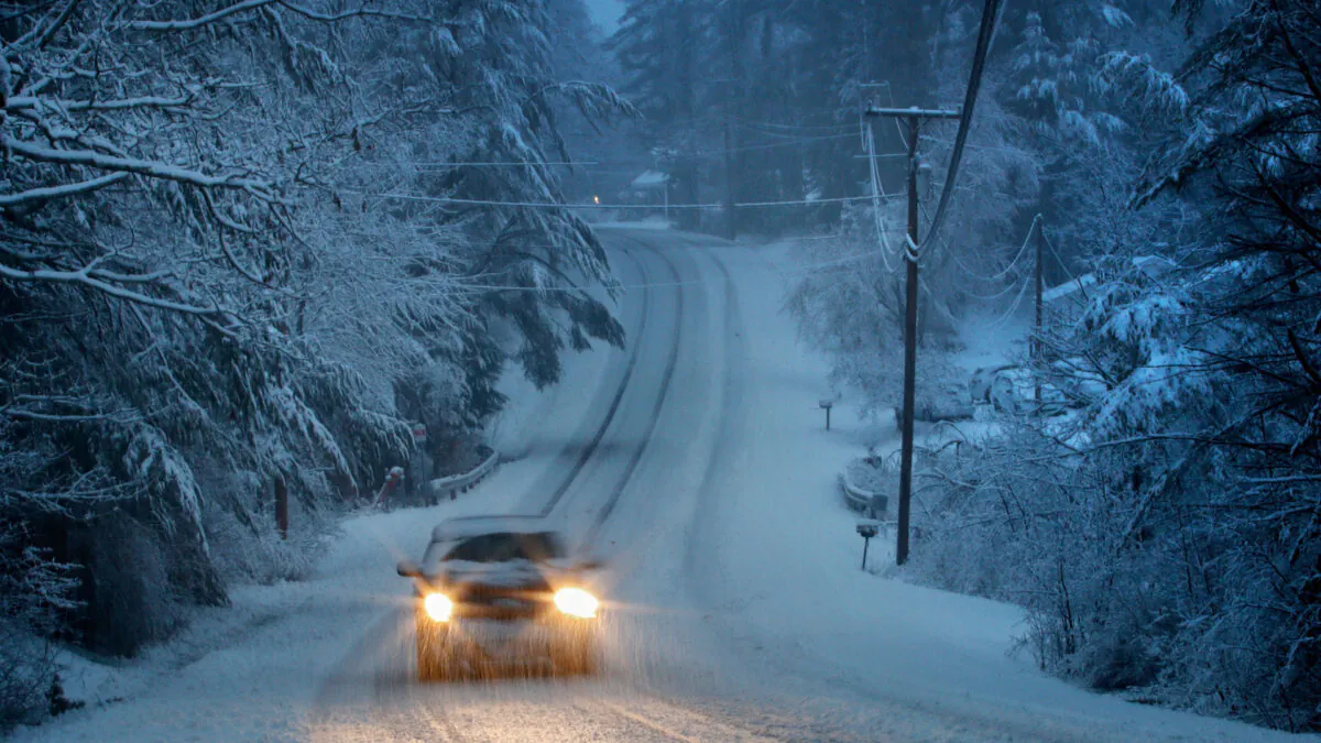 A snowstorm creates challenging driving conditions in Freeport, Maine, on April 9, 2020.  (Robert F. Bukaty/AP)