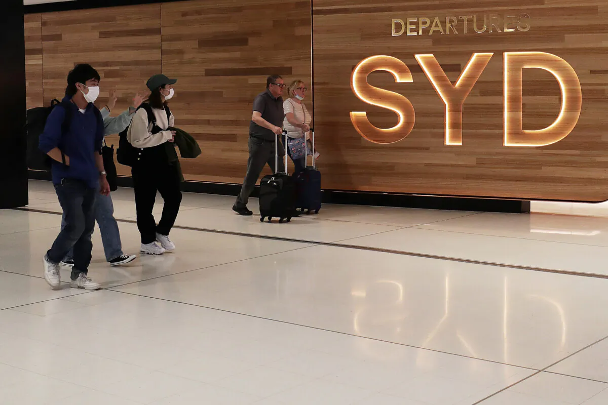 Travellers walk towards the departures gate at the International Airport  in Sydney, Australia on March 25, 2020. (Mark Metcalfe/Getty Images)