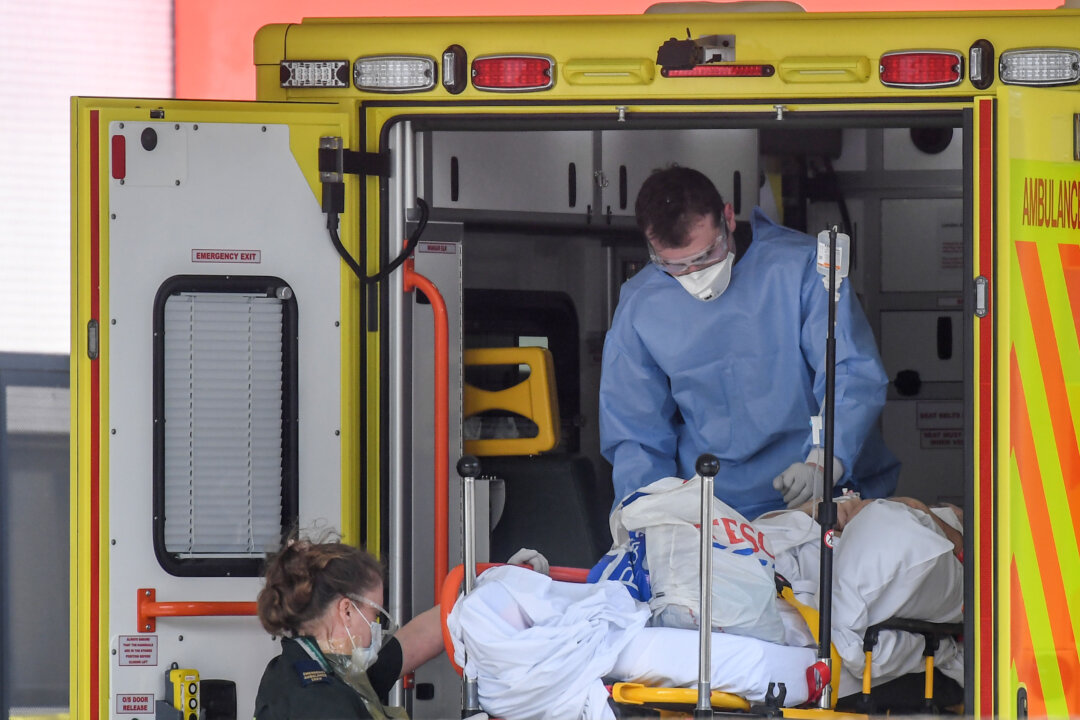 A doctor wearing protective equipment is seen unloading a patient outside St. Thomas's Hospital in London, on April 7, 2020. (Peter Summers/Getty Images)