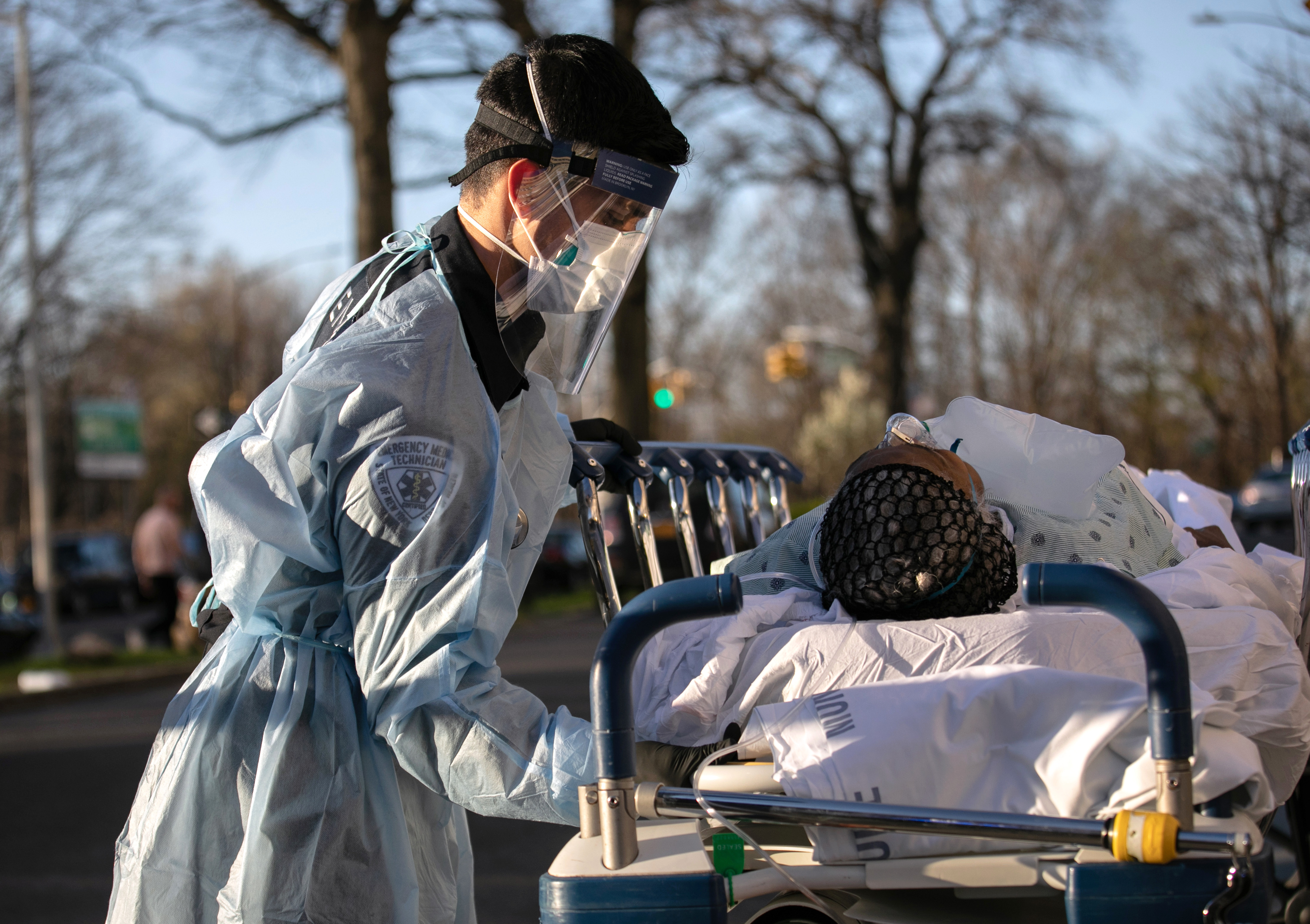 An EMT tends to a COVID-19 patient