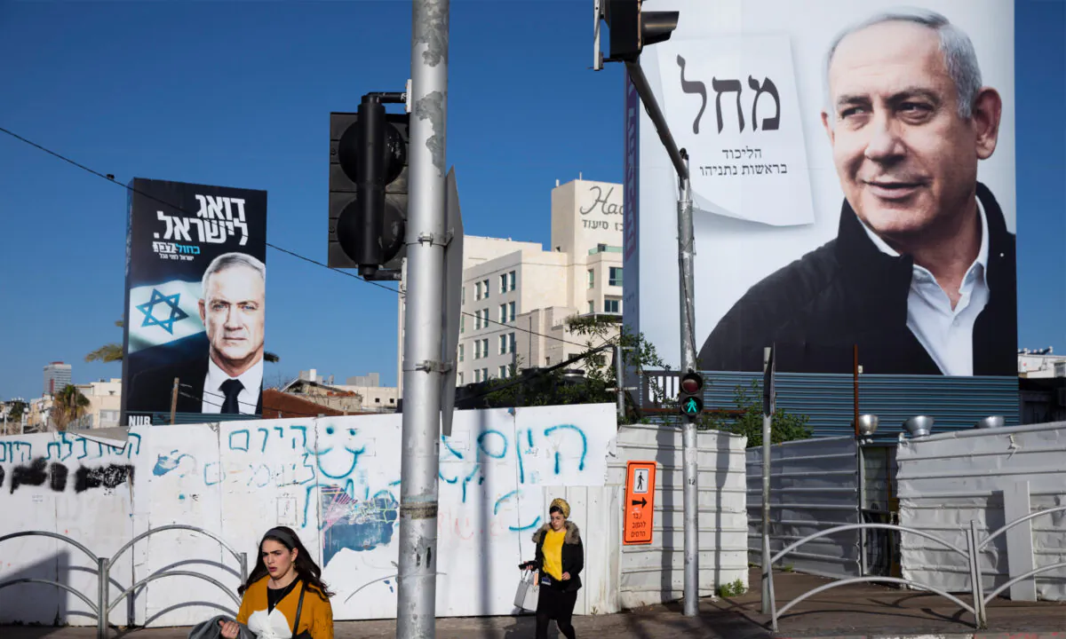 Election campaign billboards showing Israeli Prime Minister Benjamin Netanyahu (R) and Benny Gantz (L) in Bnei Brak, Israel, on March 1, 2020. (Oded Balilty/AP Photo)
