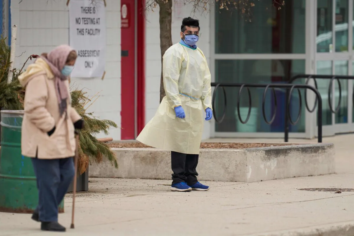 An elderly woman waits outside a COVID-19 assessment center in London, Ontario, on March 17, 2020. (Geoff Robins/AFP via Getty Images)