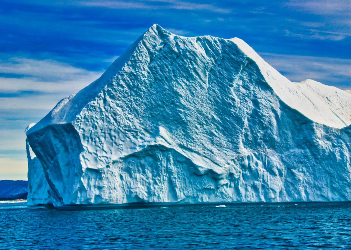 Think this iceberg is big? Often icebergs breaking from the glacier are so huge—more than 3,000 feet in height— that they’re too tall to float down the fjord. (Copyright Fred J. Eckert)