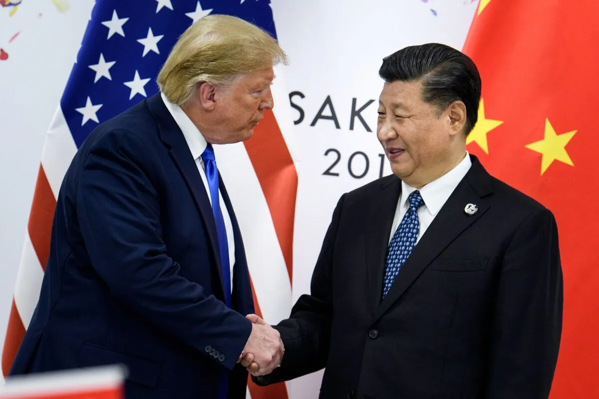 China’s leader Xi Jinping (R) shakes hands with U.S. President Donald Trump before a bilateral meeting on the sidelines of the G20 Summit in Osaka on June 29, 2019. (Brendan Smialowski/AFP via Getty Images)