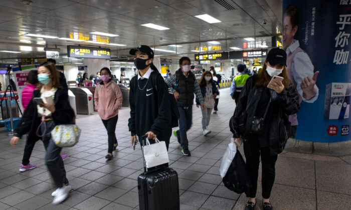 Commuters in the Taipei metro station heading home from work in Taipei, Taiwan, on March 19, 2020. (Paula Bronstein/Getty Images)