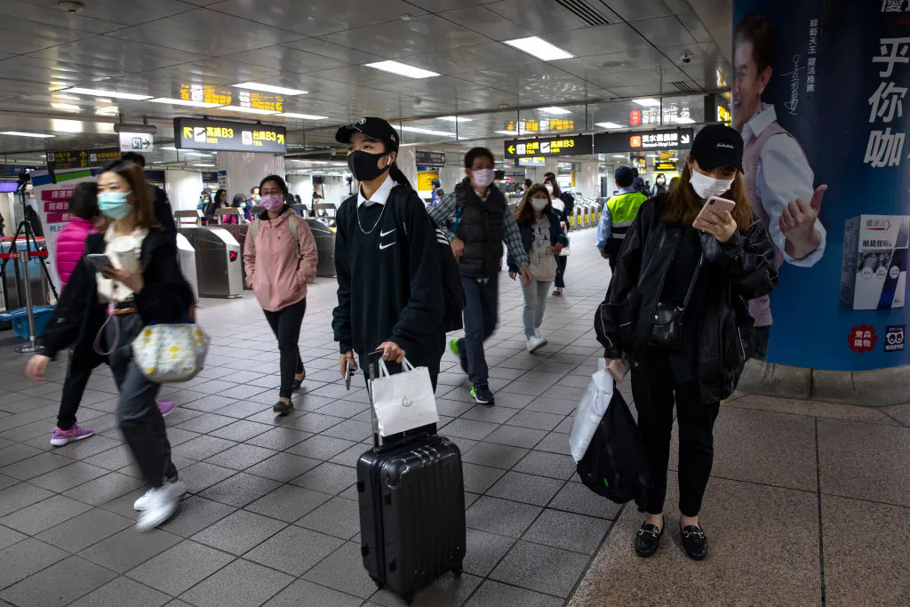 Commuters in the Taipei metro station heading home from work in Taipei, Taiwan, on March 19, 2020. (Paula Bronstein/Getty Images)
