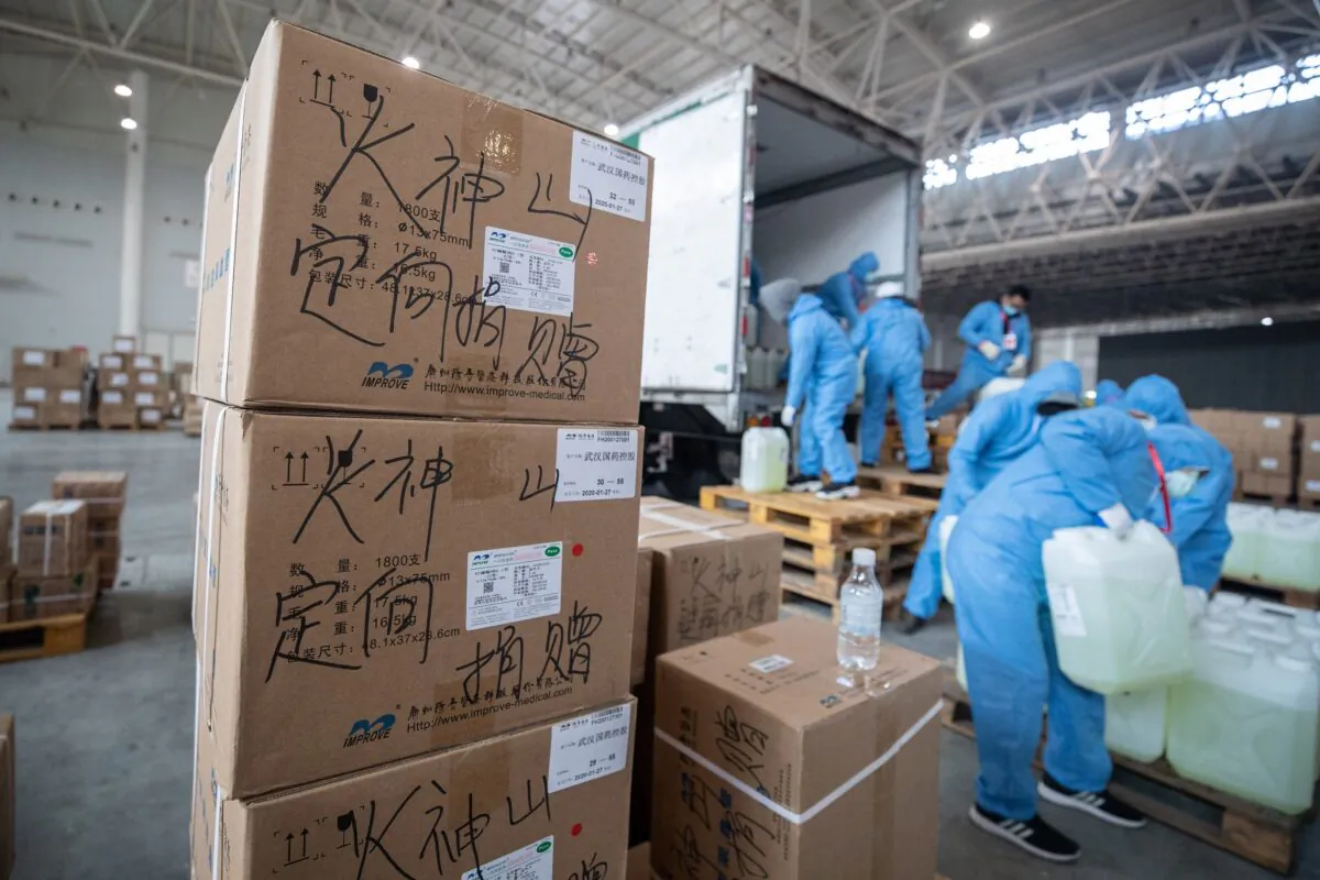 Workers transfer medical supplies at a warehouse in Wuhan, China, on Feb. 4, 2020. (STR/AFP via Getty Images)