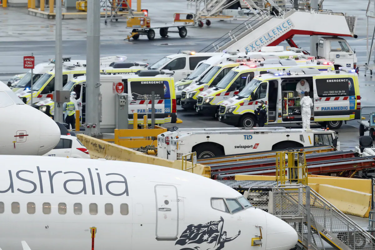 Ambulances are seen on the tarmac at Melbourne airport on April 12, 2020 in Melbourne, Australia. Over 1000 passengers arriving from Peru, Uruguay and India.(Darrian Traynor/Getty Images)