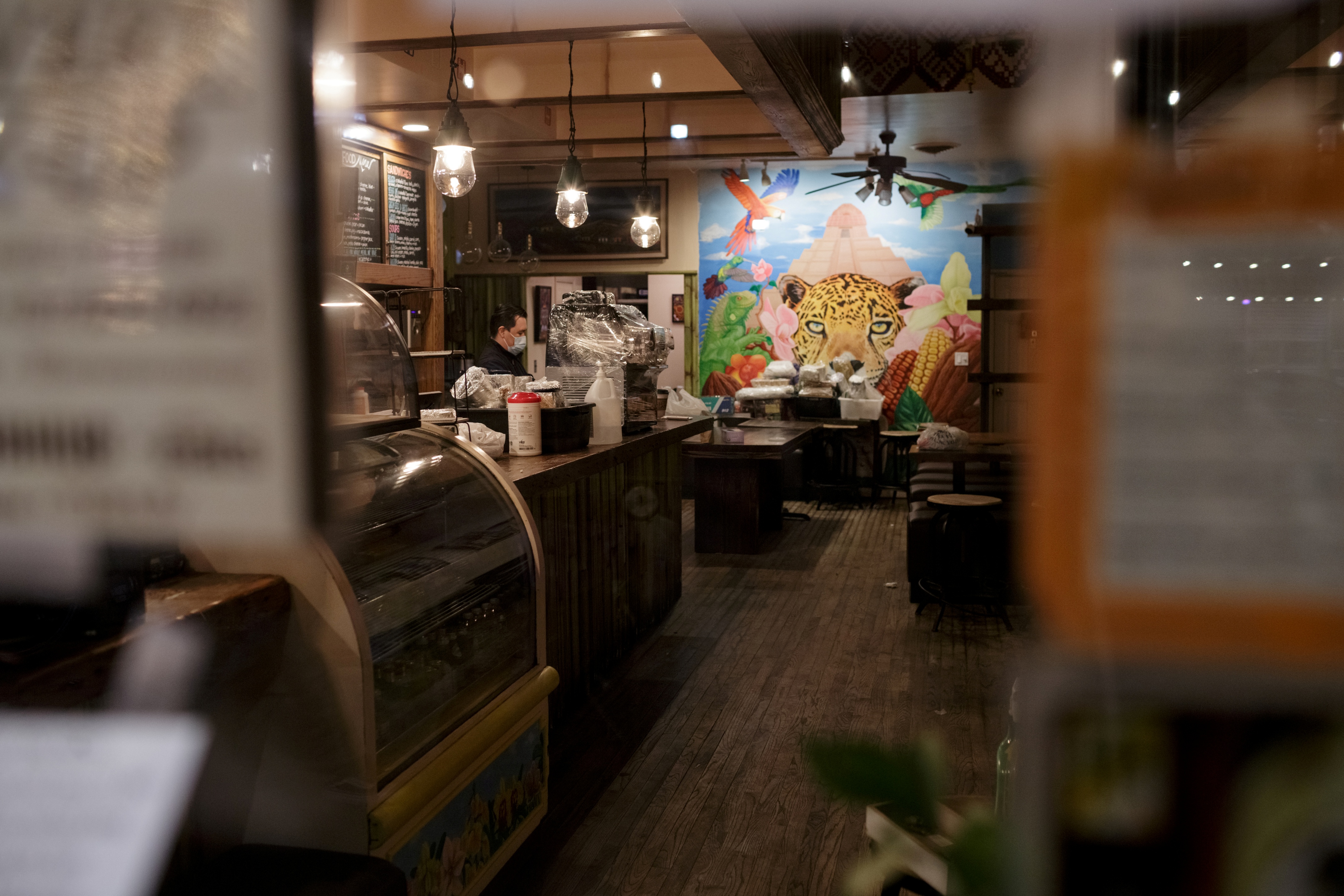 Ix, now closed for customers, is seen through the front windows as employee Daniel Gonzalez, 34, finishes cleaning and sanitizing the upstairs, in the Brooklyn borough of New York City, U.S., on April 2, 2020 amid the CCP virus outbreak. (Anna Watts/Reuters)