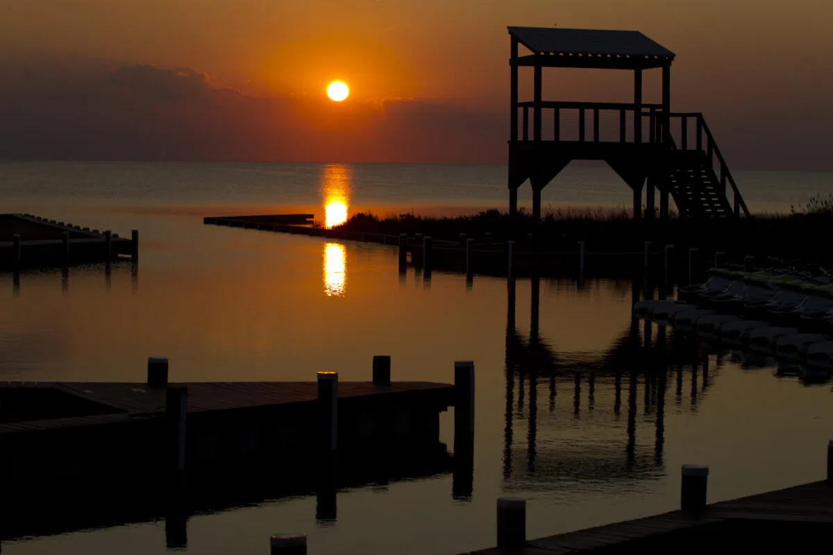 A sunset as seen on the quiet waters of the Rodanthe Sound shore on the Outer Banks of Dare County, North Carolina. It is questionable whether six out-of-the-state estate owners in the region will ever see a sunset from their property any time soon after the Dare County Control Group determined that they will be banned from accessing their homes on March 20 (Jose Luis Magana/AFP/Getty Images)
