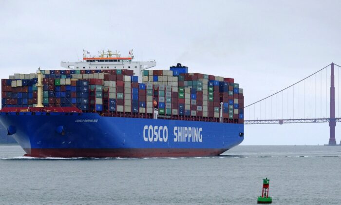 A China Ocean Shipping Company container ship passes the Golden Gate Bridge in San Francisco on May 14, 2019, bound for the Port of Oakland. (AP Photo/Eric Risberg)