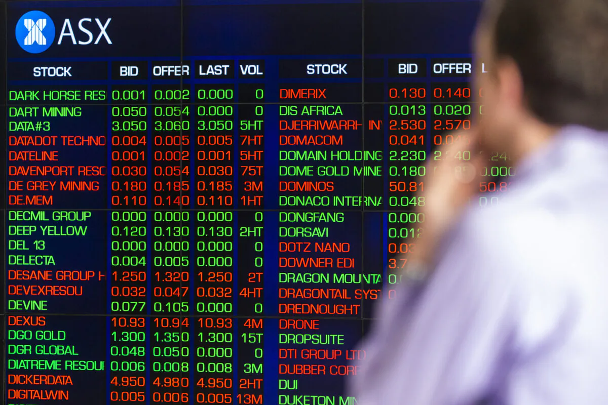 A man looks at the electronic display of stocks at the Australian Stock Exchange on March 13, 2020 in Sydney, Australia. (Photo by Jenny Evans/Getty Images)