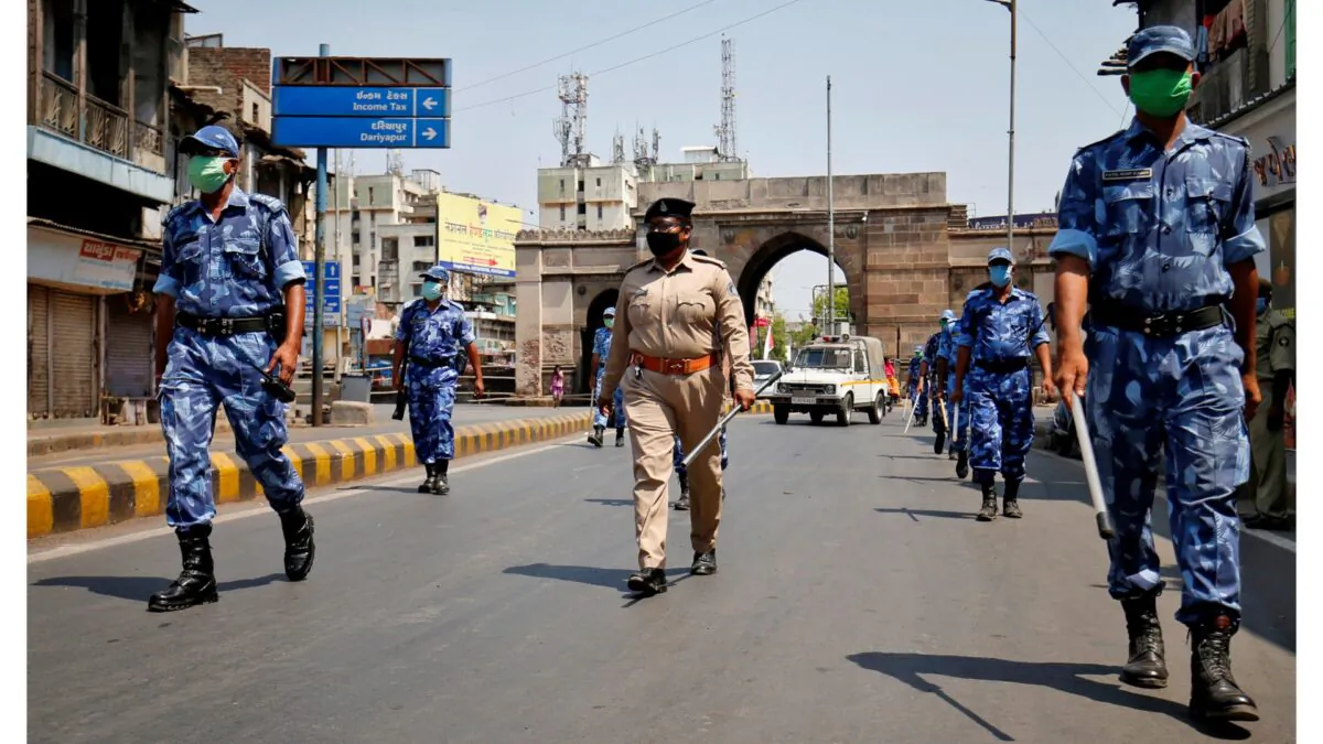 Members of Rapid Action Force (RAF) patrol an empty street after India extended a nationwide lockdown to slow the spreading of the CCP virus in Ahmedabad, India on April 14, 2020. (Amit Dave/Reuters)