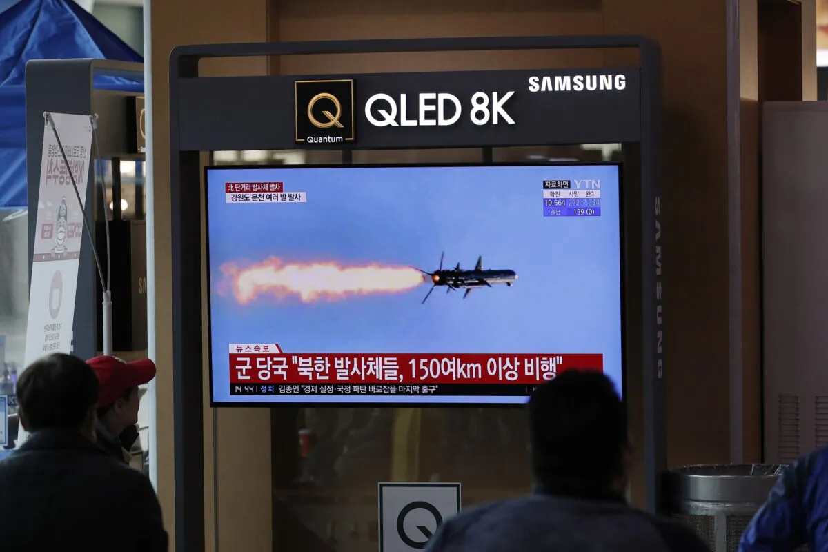 People watch a TV screen showing a news program reporting about North Korea's missiles with a file image at the Seoul Railway Station in Seoul on April 14, 2020. (Lee Jin-man/AP Photo)