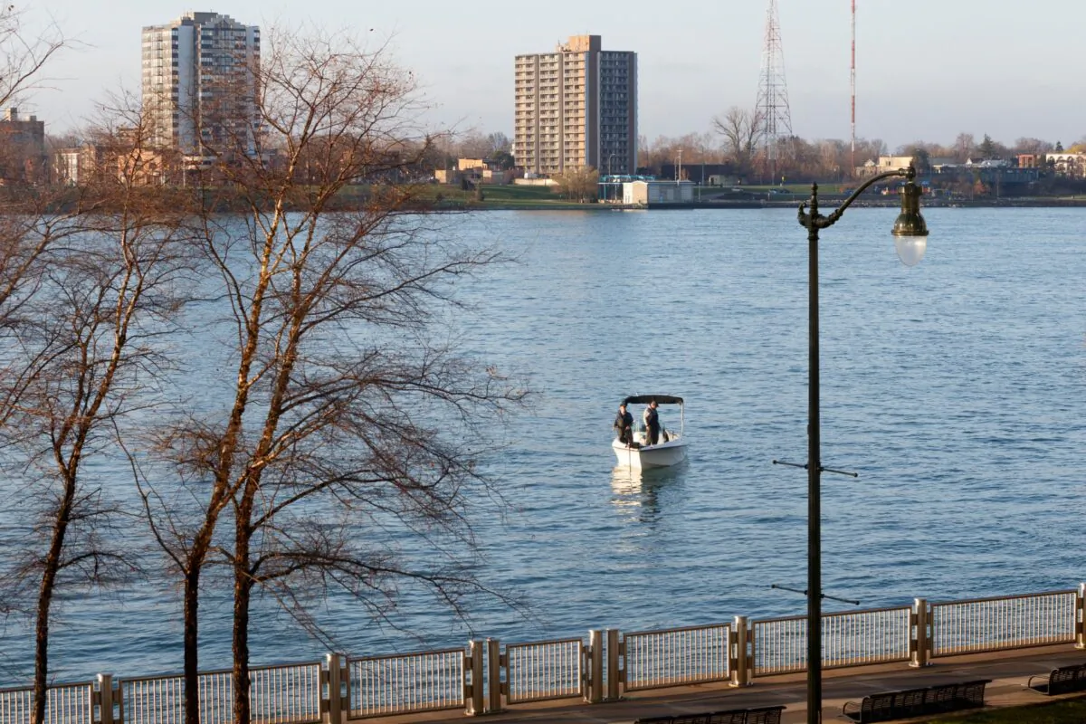 Two people fish from a boat on the Detroit River across from Windsor, Ontario, in Detroit, Mich., on April 8, 2020. (Elaine Cromie/Getty Images)