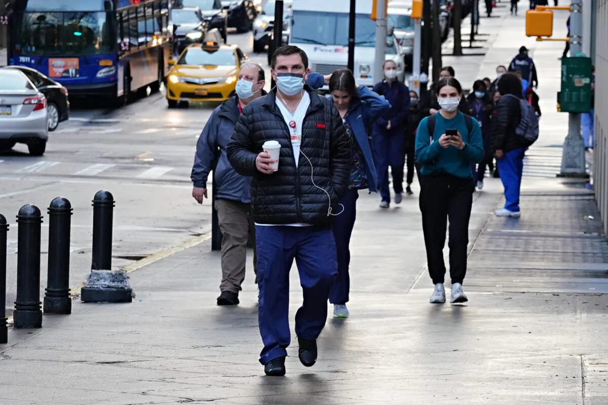 Medical staff arrive for their shift at NewYork-Presbyterian Hospital/Weill Cornell Medical Center during the CCP virus outbreak in New York City on April 13, 2020. (Cindy Ord/Getty Images)
