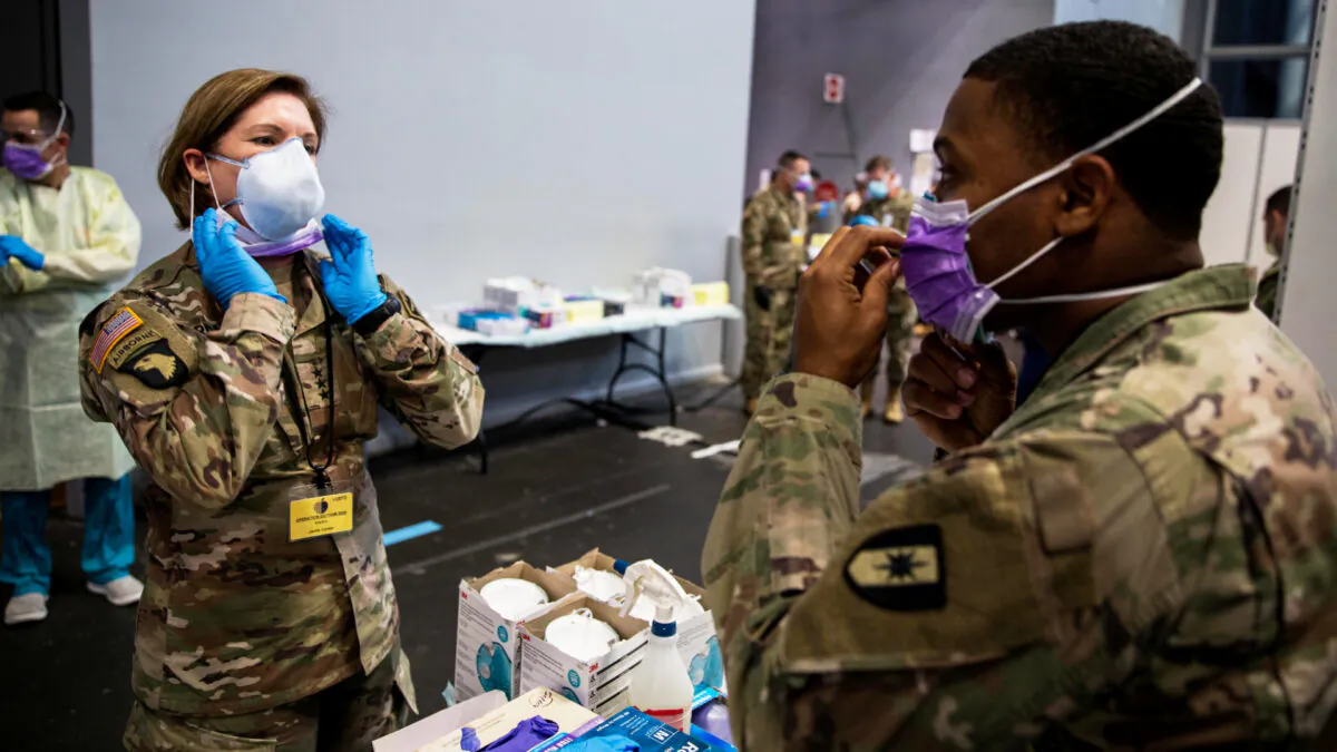 Army Lieutentant General Laura Richardson, commanding general of U.S. Army North, puts on personal protective equipment before entering the patient care area at Javits New York Medical Station, which is supporting local hospitals treating coronavirus disease (COVID-19) in New York City, on April 12, 2020. (U.S. Navy/Chief Mass Communication Specialist Barry Riley/Handout via Reuters)

