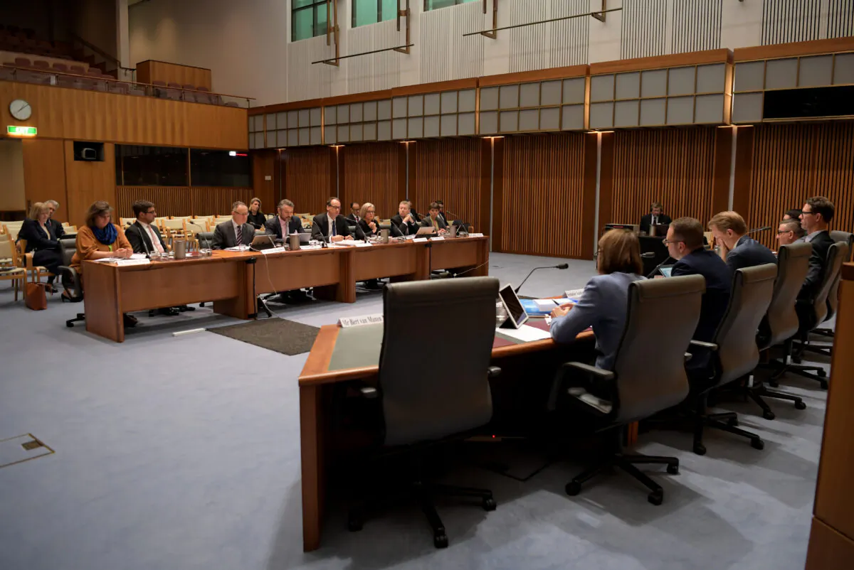 Chair, James Shipton from The Australian Securities and Investments Commission (ASIC) (C) and the 7 ASIC members sit in front of the committee during a public hearing in front of the Parliamentary Joint Committee on Corporations and Financial Services at Parliament House on Sept. 13, 2019 in Canberra, Australia. (Tracey Nearmy/Getty Images)